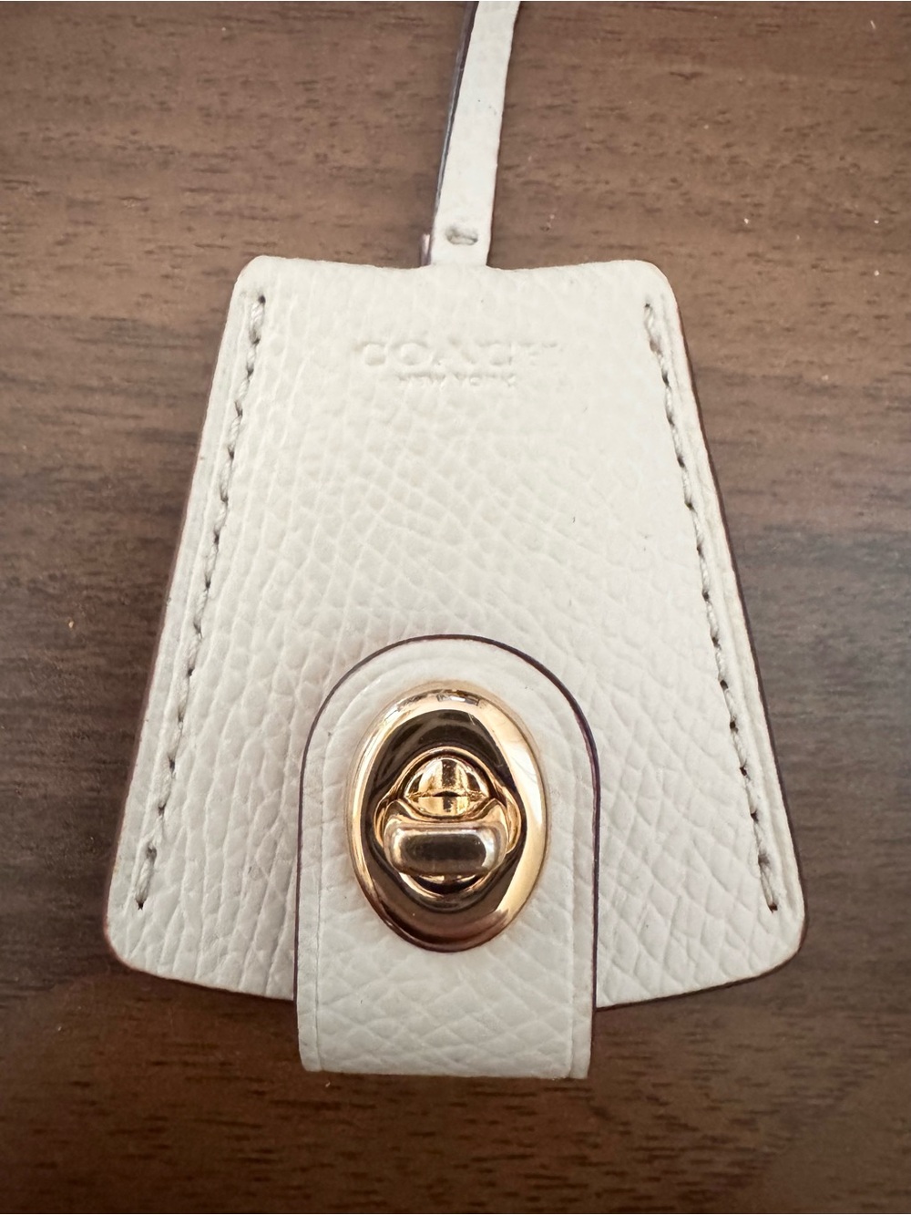 Coach Turn lock clochette ivory leather bag charm hang tag